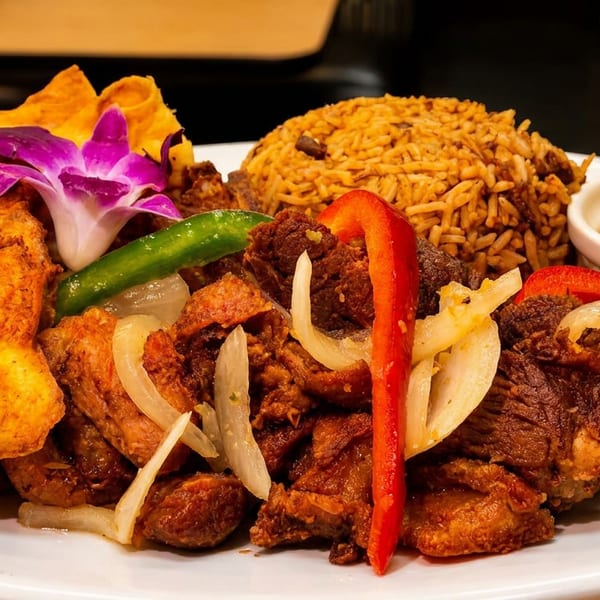 A vibrant dish with fried plantains, seasoned rice, stewed meat, onions, peppers, and a purple orchid.