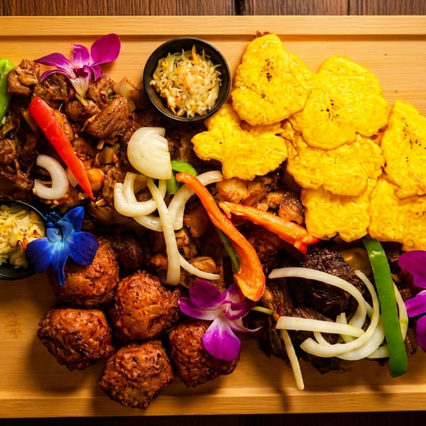A wooden platter filled with various dishes, including plantains, meat, and vegetables, garnished with orchids.